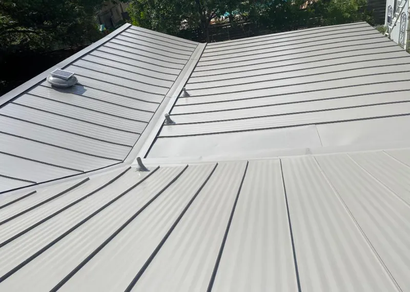 Solar attic fan installed on a metal roof for Roof Ventilation in Decorah